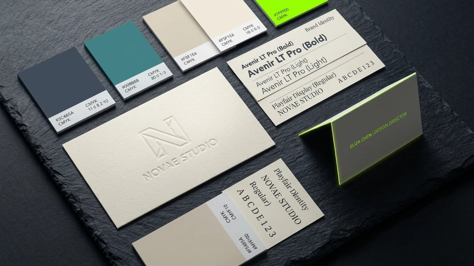 Brand identity board shot from above with colour chips, type specimen strips and a business card